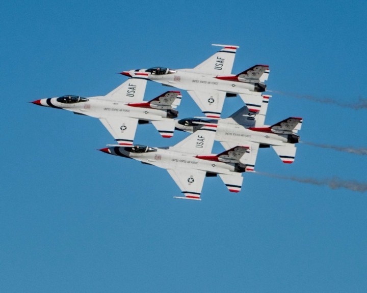 Air Force Thunderbirds flying in close formation showcasing peak performance leadership